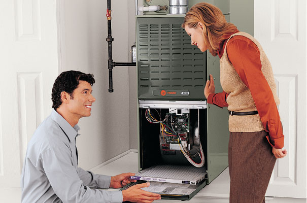 Image of technician showing homeowner how to maintain the furnace filter